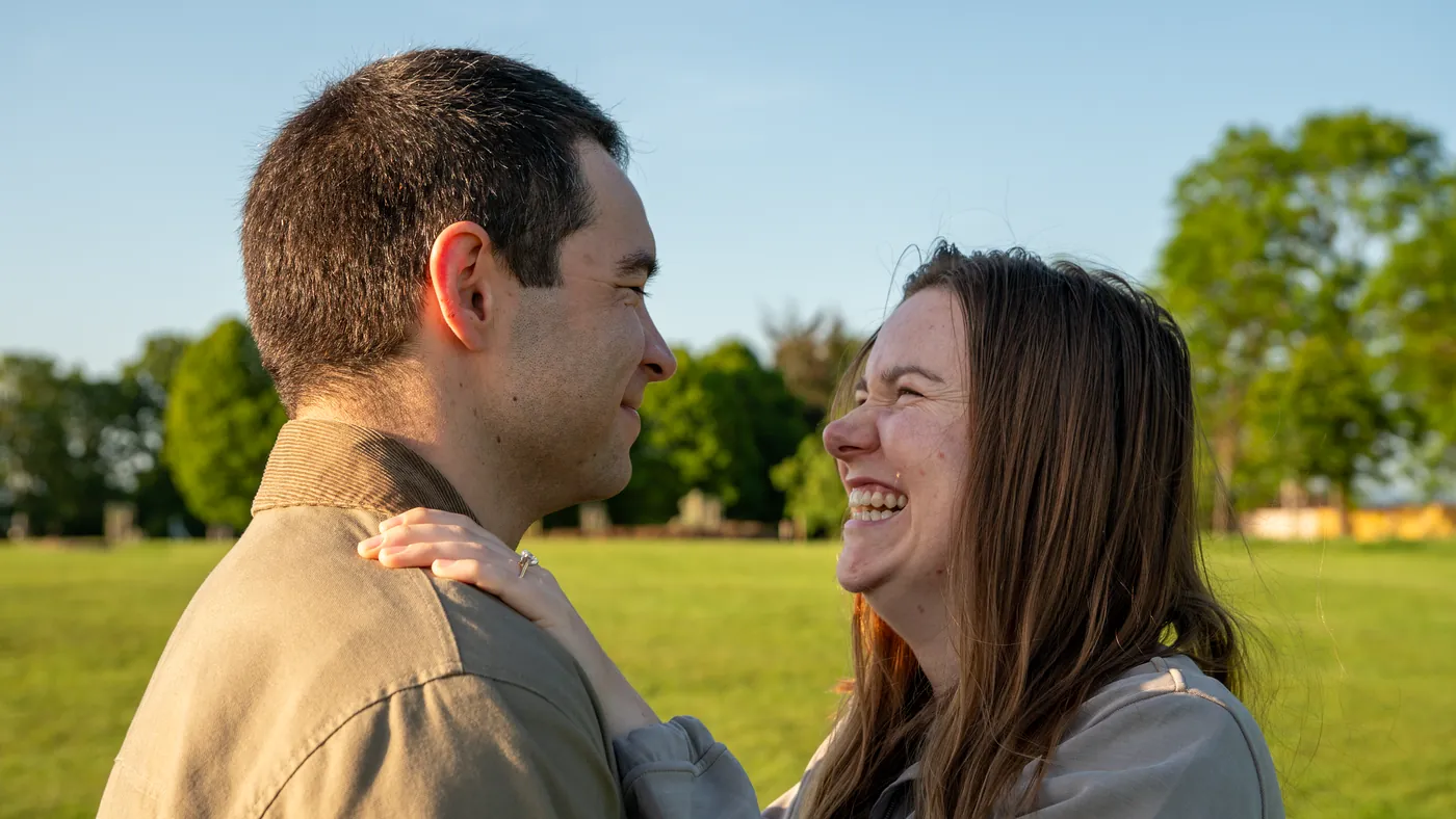 Surprise proposal photographer London capturing a newly engaged couple laughing